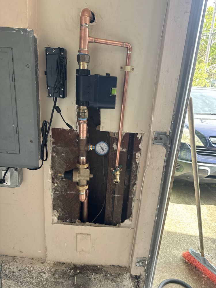 Water pressure regulating valve and gauge installed on a copper main line at a Dallas property